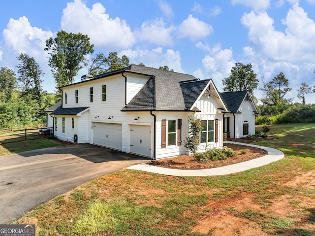 view of front of property with a garage and a front lawn