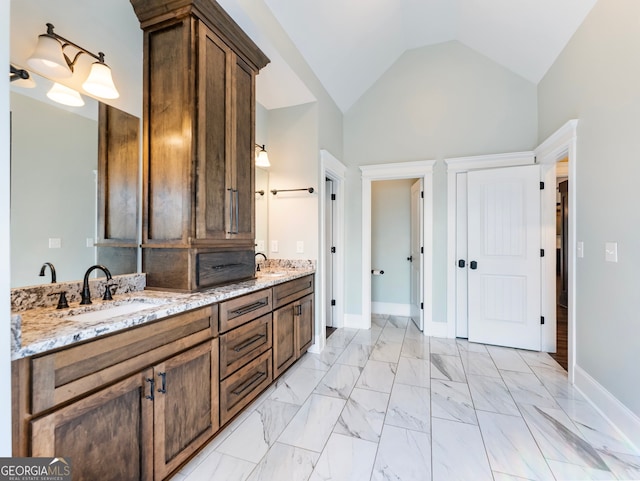 bathroom with lofted ceiling and vanity