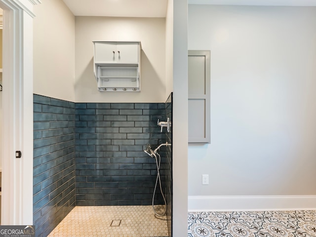 bathroom featuring tile patterned floors and a tile shower