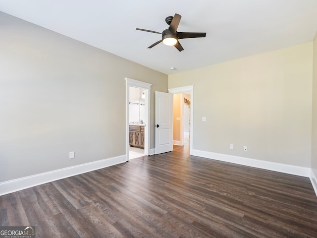 unfurnished bedroom featuring dark wood-type flooring, ceiling fan, and connected bathroom