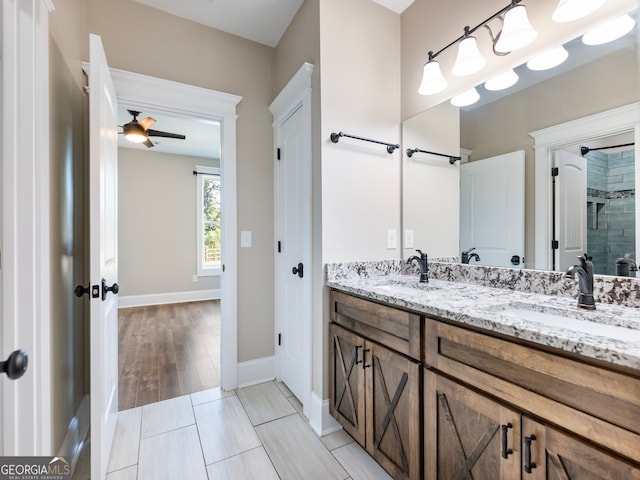 bathroom featuring vanity, hardwood / wood-style floors, a shower, and ceiling fan