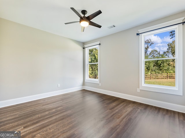 spare room featuring ceiling fan and dark hardwood / wood-style floors