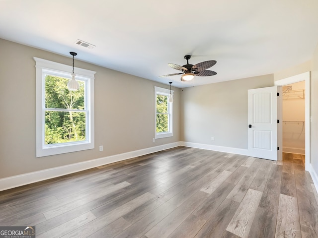 empty room with wood-type flooring and ceiling fan