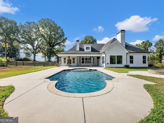 view of swimming pool with a lawn and a patio