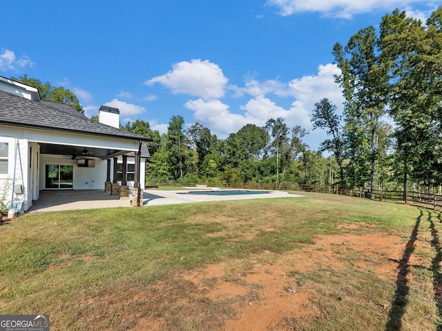 view of yard with ceiling fan, a fenced in pool, and a patio area