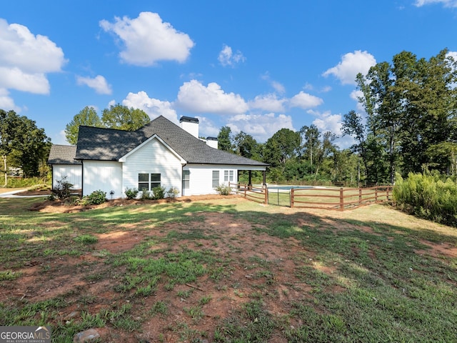 rear view of property with a yard