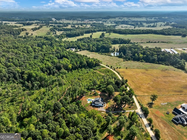 birds eye view of property with a rural view