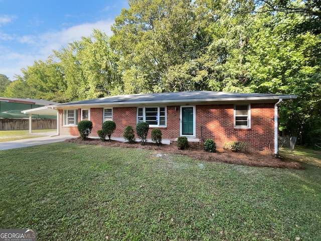 ranch-style house with a carport and a front yard