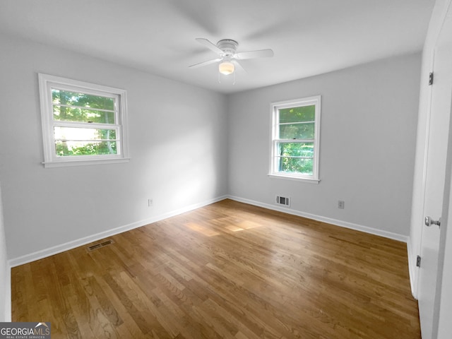 unfurnished room featuring hardwood / wood-style floors and ceiling fan