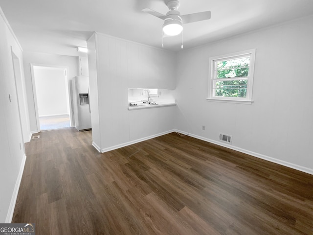 spare room featuring dark hardwood / wood-style flooring, sink, and ceiling fan