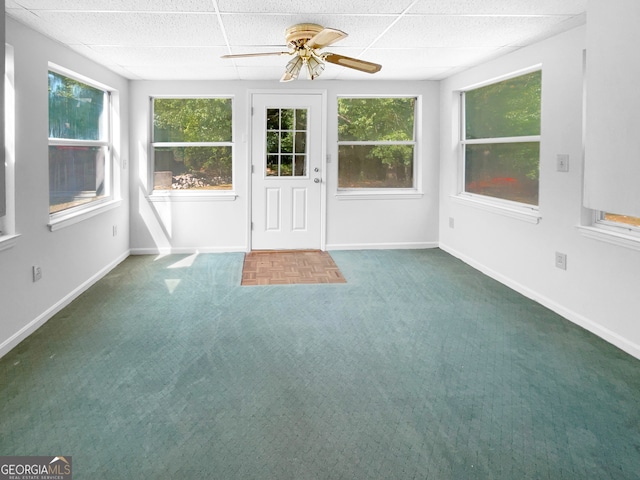 unfurnished sunroom with ceiling fan