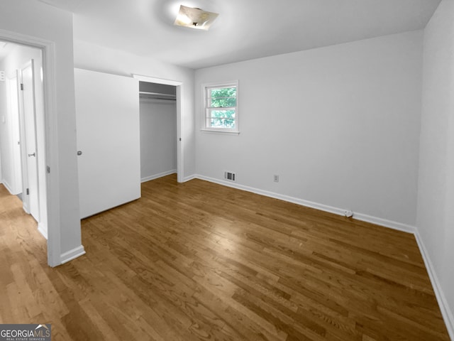 unfurnished bedroom featuring a closet and light wood-type flooring