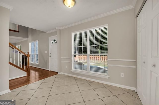 entryway featuring crown molding and light hardwood / wood-style floors