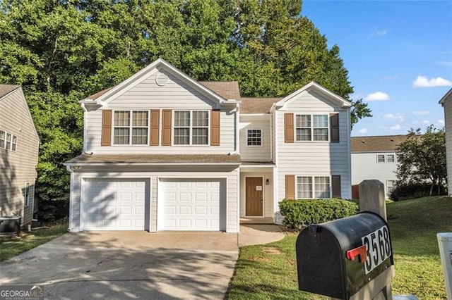 view of front of property with a garage and a front yard