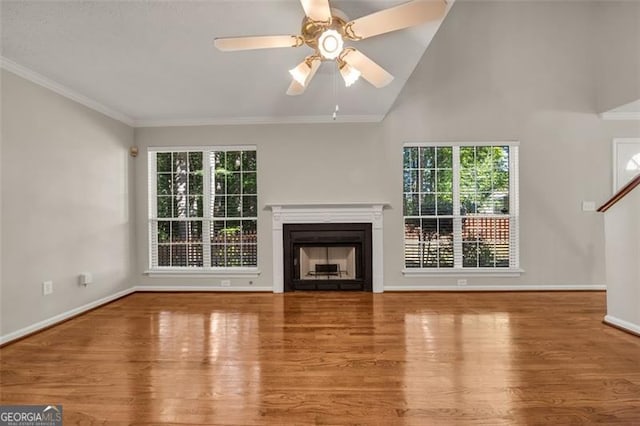 unfurnished living room with high vaulted ceiling, ceiling fan, light hardwood / wood-style floors, and ornamental molding