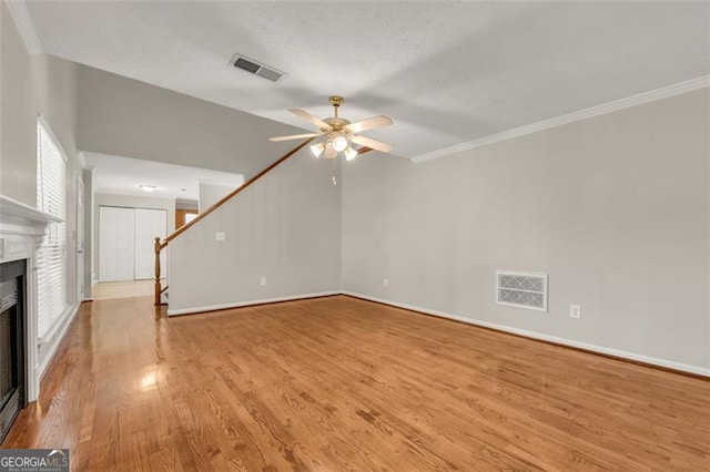 unfurnished living room with crown molding, light hardwood / wood-style flooring, and ceiling fan