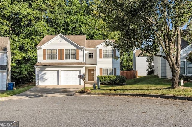 view of property featuring a garage and a front yard