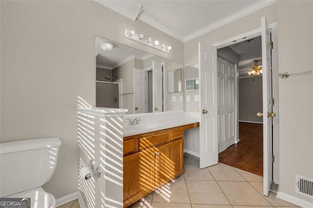 bathroom with ornamental molding, vanity, toilet, and hardwood / wood-style floors