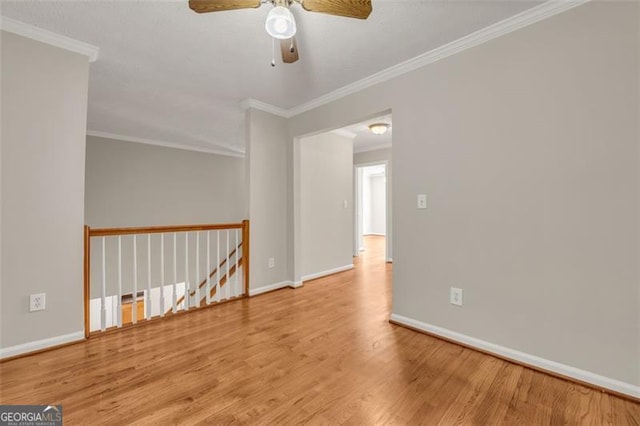 unfurnished room featuring ceiling fan, ornamental molding, and light wood-type flooring