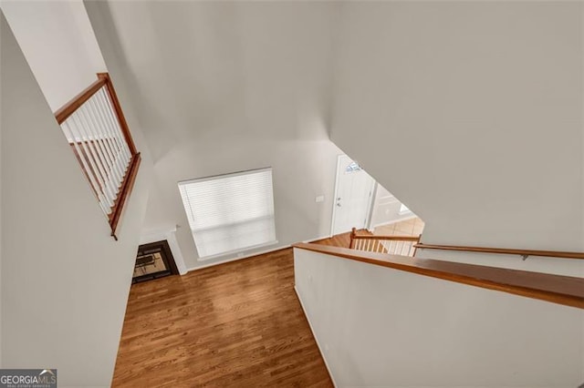 staircase featuring plenty of natural light and hardwood / wood-style flooring