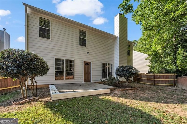 back of property featuring a lawn and a patio