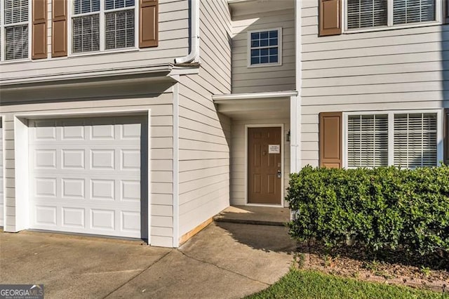 doorway to property with a garage