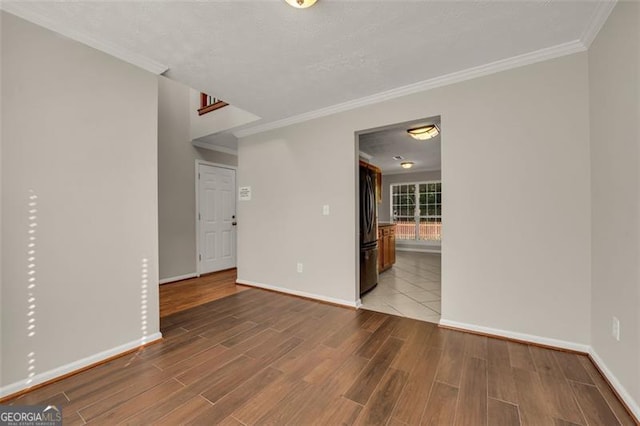 unfurnished living room with ornamental molding and hardwood / wood-style flooring