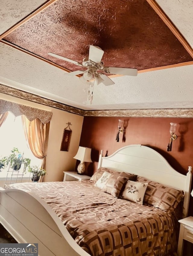 bedroom featuring ceiling fan and ornamental molding