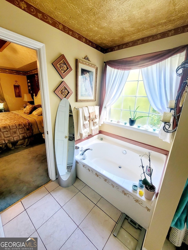 bathroom with a bathtub and tile patterned flooring