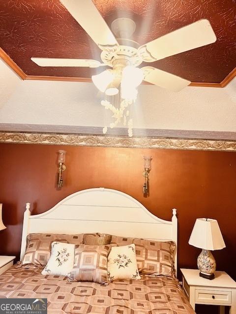 bedroom featuring ceiling fan and crown molding