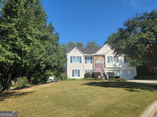 bi-level home featuring a front yard and a garage