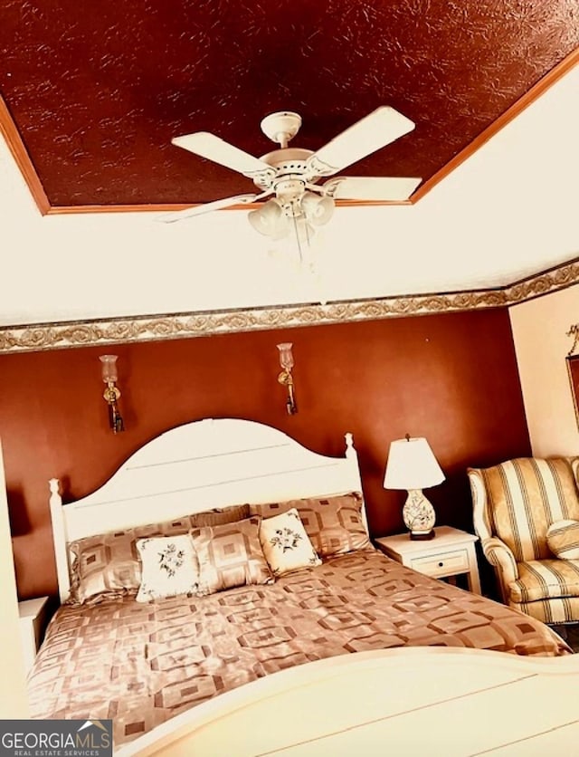 bedroom featuring ceiling fan, ornamental molding, and vaulted ceiling