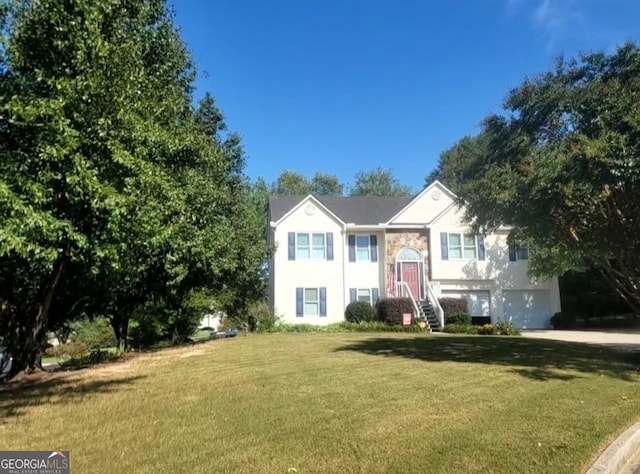 split foyer home with a front lawn and a garage