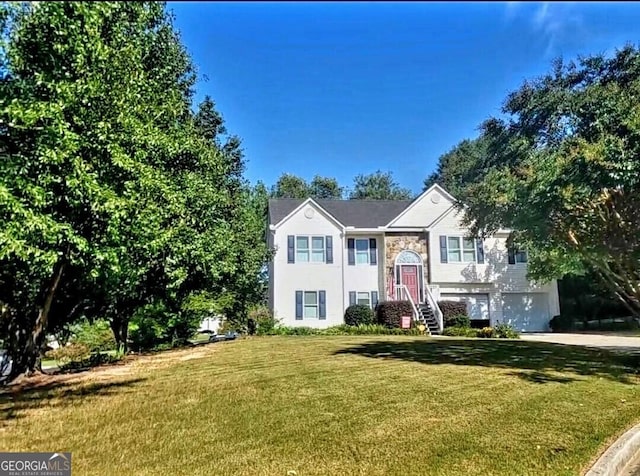 bi-level home with a front yard and a garage