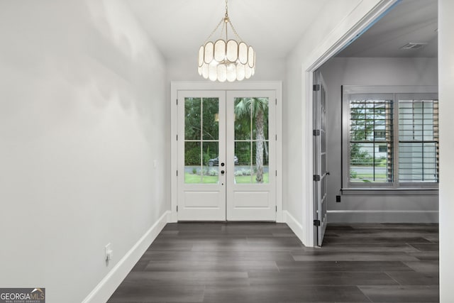 entryway featuring an inviting chandelier, dark hardwood / wood-style flooring, and french doors