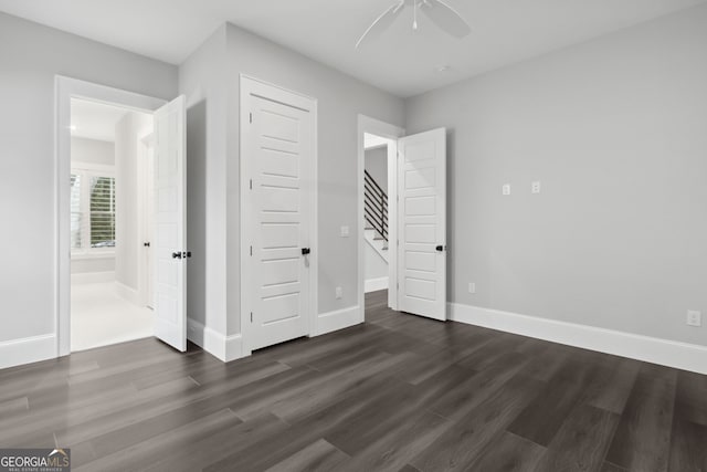 unfurnished bedroom featuring ceiling fan and dark hardwood / wood-style flooring