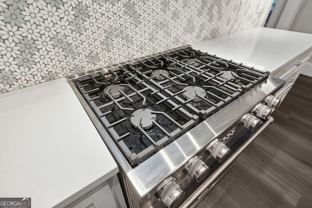 room details featuring dark hardwood / wood-style floors and tasteful backsplash