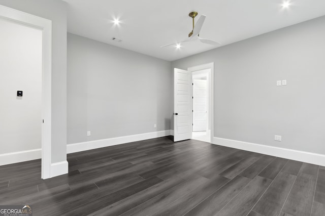 spare room with ceiling fan and dark wood-type flooring