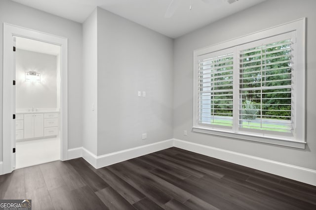 spare room with dark hardwood / wood-style floors and ceiling fan