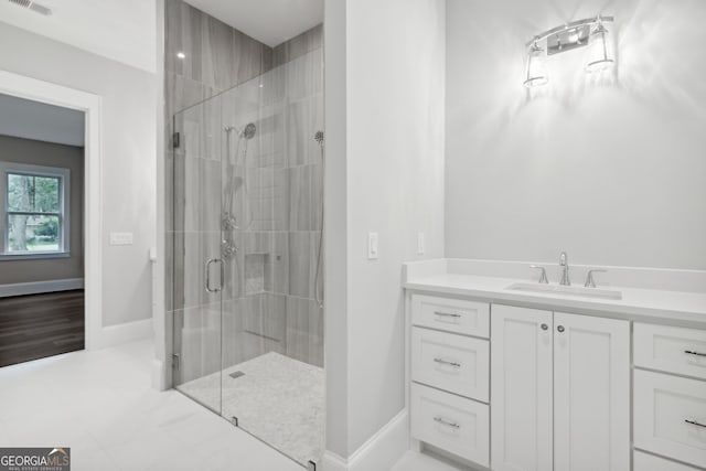 bathroom featuring vanity and an enclosed shower