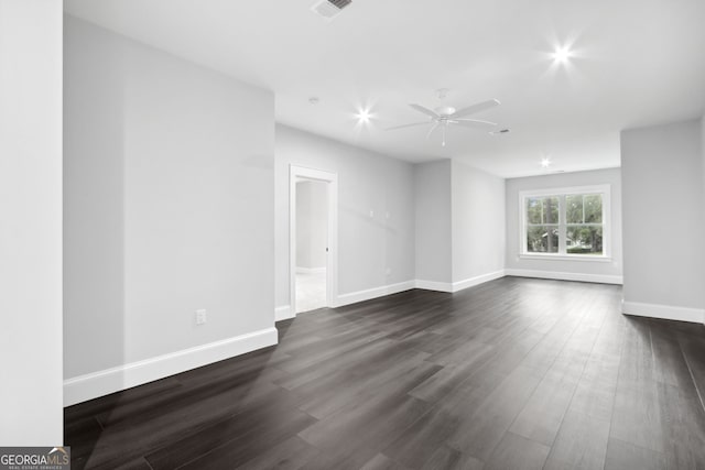 empty room featuring ceiling fan and dark wood-type flooring