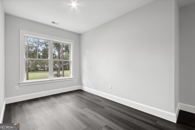 spare room featuring dark hardwood / wood-style floors