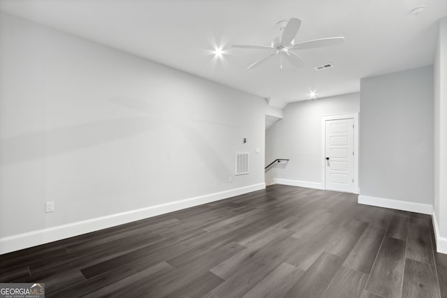 unfurnished living room featuring ceiling fan and dark wood-type flooring