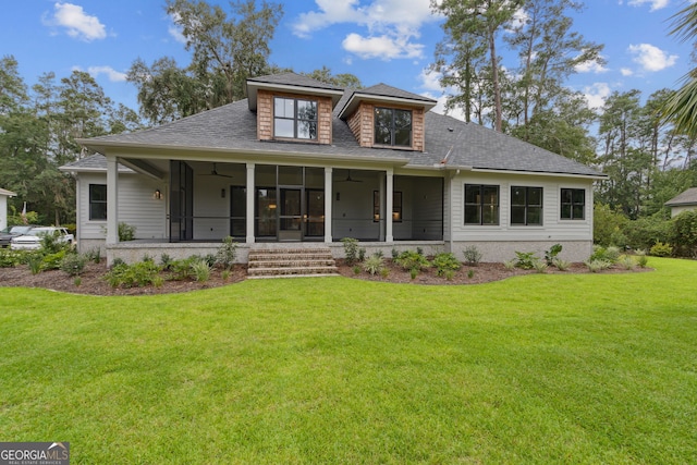 view of front of home featuring a sunroom, ceiling fan, and a front yard