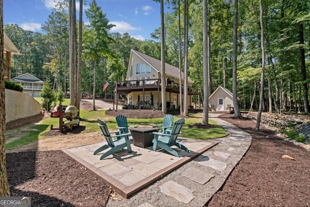 view of patio / terrace featuring a fire pit and a wooden deck