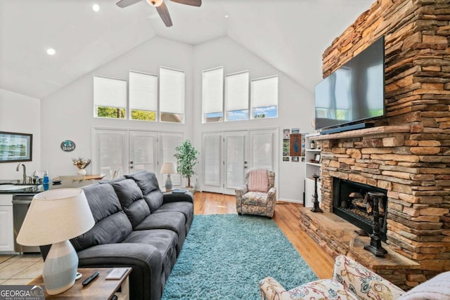 living room with french doors, high vaulted ceiling, and light hardwood / wood-style flooring