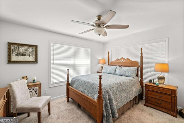 bedroom with ceiling fan and light carpet