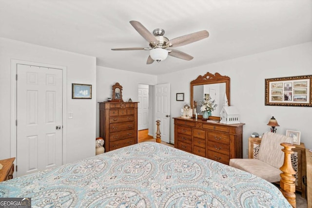 bedroom with wood-type flooring, a closet, and ceiling fan