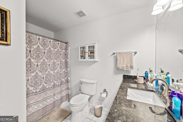 bathroom featuring tile patterned flooring, vanity, and toilet