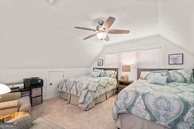 bedroom with ceiling fan, light colored carpet, and vaulted ceiling